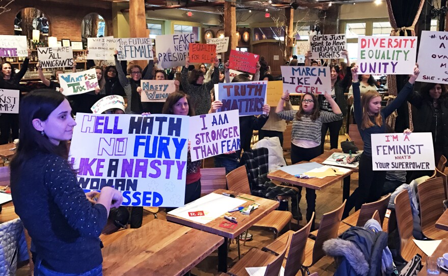 Protesters hold up their handmade signs as they prepare for the Women's March on Washington.