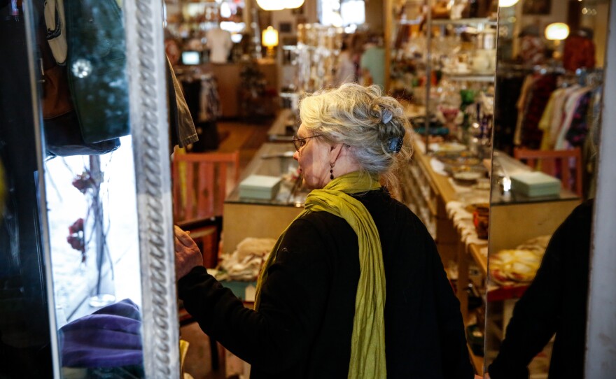 Hamtramck Mayor Karen Majewski looks into her store, Tekla Vintage, located downtown.