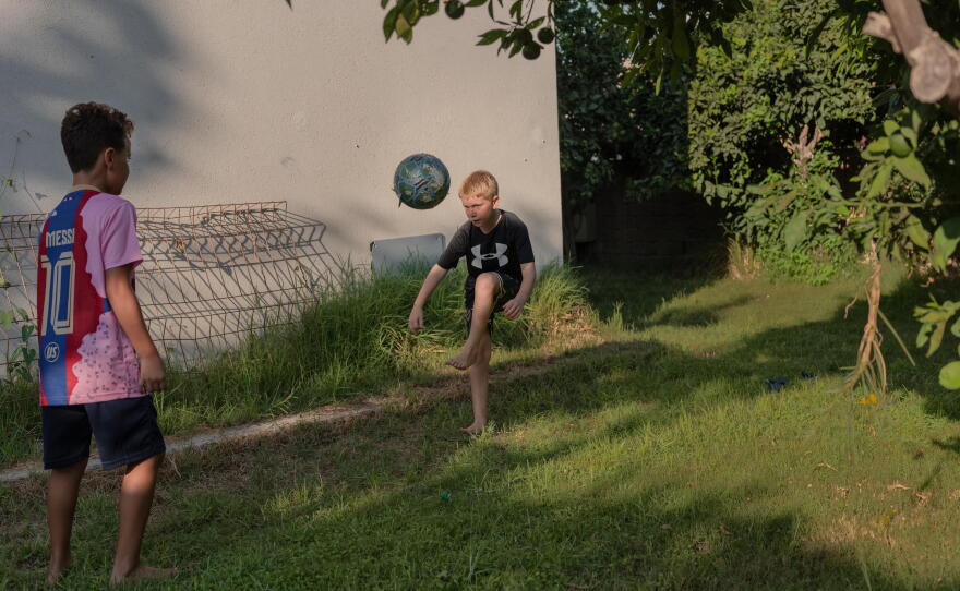 Shahar Goldenberg's Yoav plays with his friend outside their home in Kibbutz Zikim, Israel on Aug. 31, 2026.