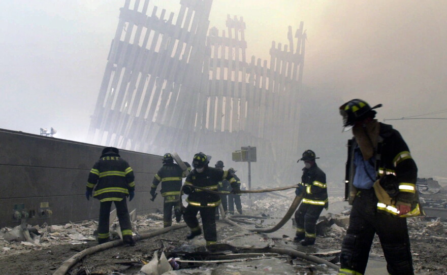 Firefighters work at the site of the destroyed World Trade Center in New York City on Sept. 11, 2001.