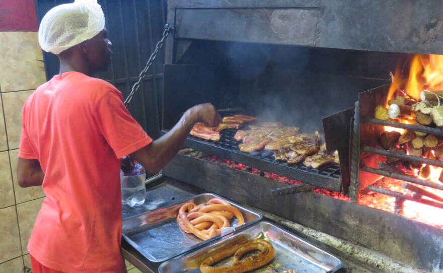 Braii is South African for barbecue. Here, meat is roasted over wood at Mzoli's, a popular butcher and grill in Gugulethu township.