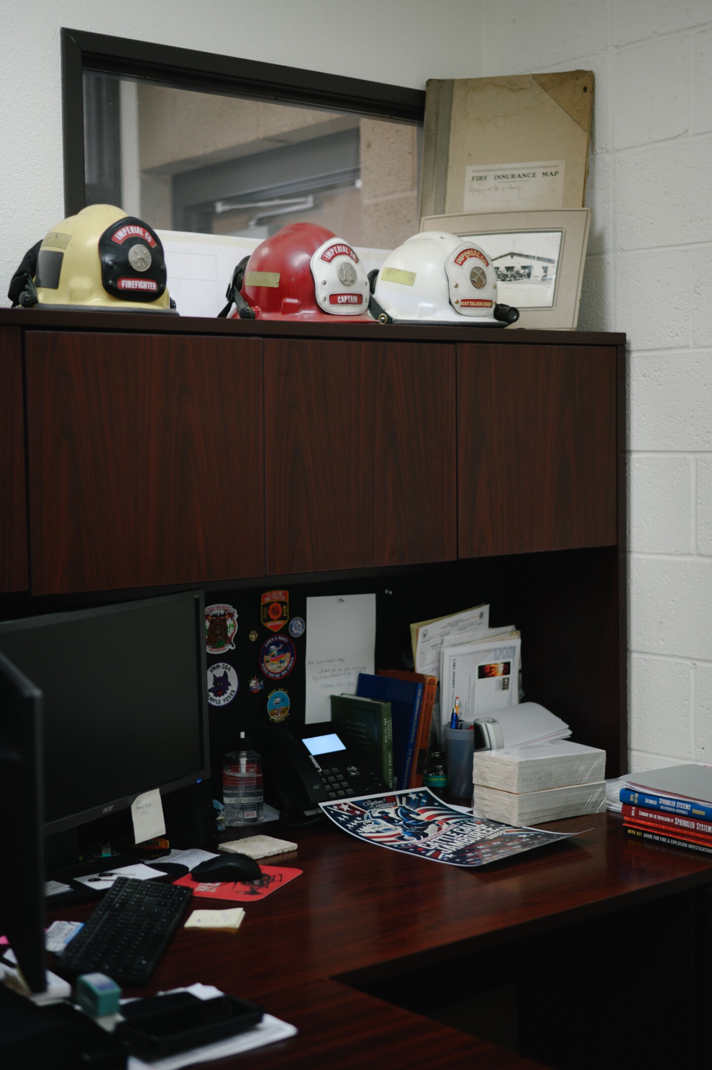 The desk of Juan Rodelo, a firefighter and amateur photographer, at his fire station in Brawley, Calif. in Imperial County on Oct. 18, 2024.
