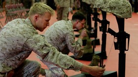Lance Corp Gerry Murphy, front, prays for a fellow Marine killed in action during a memorial service February 6, 2009 at Camp Pendleton, California.
