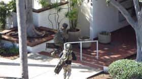 Two members of the San Diego police SWAT team respond to an incident at an apartment complex in Bankers Hill, Nov. 4, 2015.