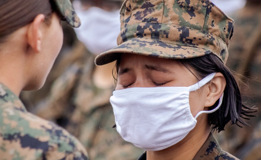 Pfc. Emily Sandoval crying as she receives her Eagle, Globe and Anchor emblem and title U.S. Marine from her drill instructor atop the Reaper, the highest point in Camp Pendleton, April 22, 2021.