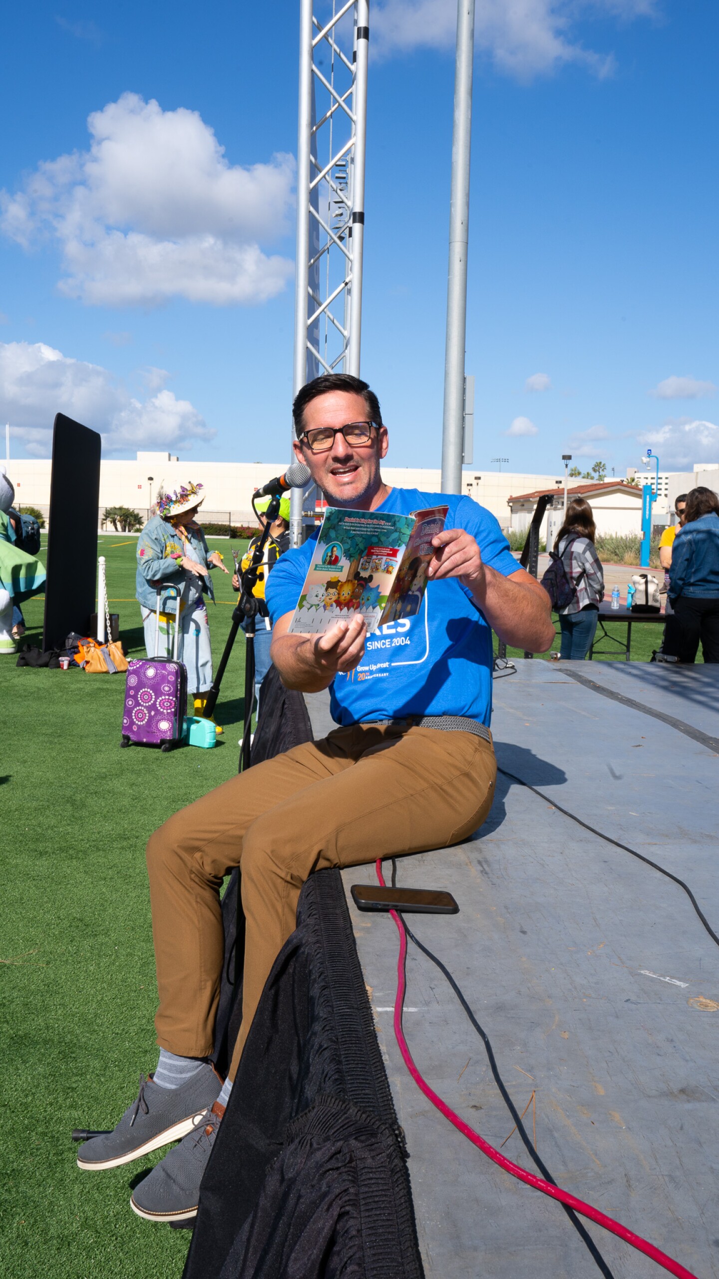 Alan Prohaska, PNC Bank Regional President of Greater San Diego, shares a Daniel Tiger story at Be My Neighbor Day across the street from the KPBS station on Saturday, April 6 in San Diego, CA.