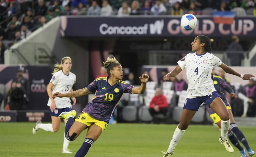 United States defender Naomi Girma (4) heads the ball over Colombia defender Jorelyn Carabali (19) during the first half of a CONCACAF Gold Cup women's soccer tournament quarterfinal, Sunday, March 3, 2024, in Los Angeles.
