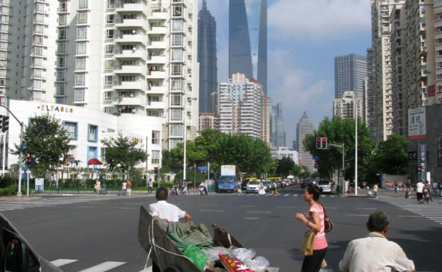 <p>Despite its ultra-modern skyscrapers and paved streets, some Shanghai residents still transport items on carts.</p>