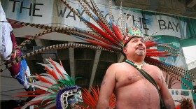 Victor Ochoa's "All The Way To The Bay" mural in the backdrop as participants prepare for a parade on Chicano Park Day in 2007. Ochoa is currently restoring this mural. 
