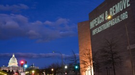 A message promoting an upcoming "No Kings" protest is projected on the National Gallery of Art, with the U.S. Capitol seen in the background, on Monday, March 23, 2026, in Washington.