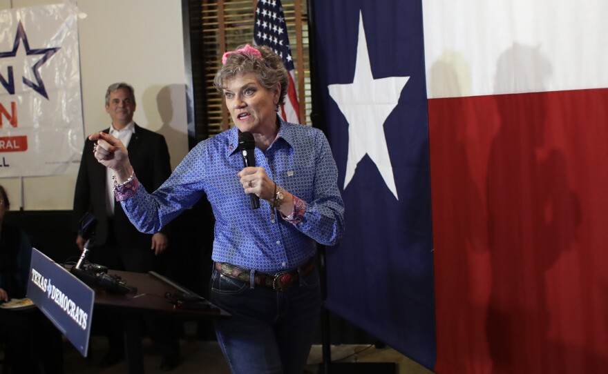 Wearing pink ears, Kim Olson, Democratic candidate for Texas Agriculture Commissioner, addresses supporters during a Democratic watch party following the Texas primary election, Tuesday, March 6, 2018, in Austin, Texas.