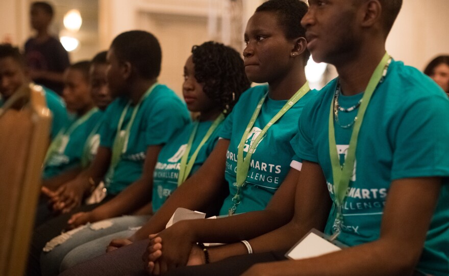 Members of Team McKwiny clasp hands in anticipation of the awards announcement. They came in second.