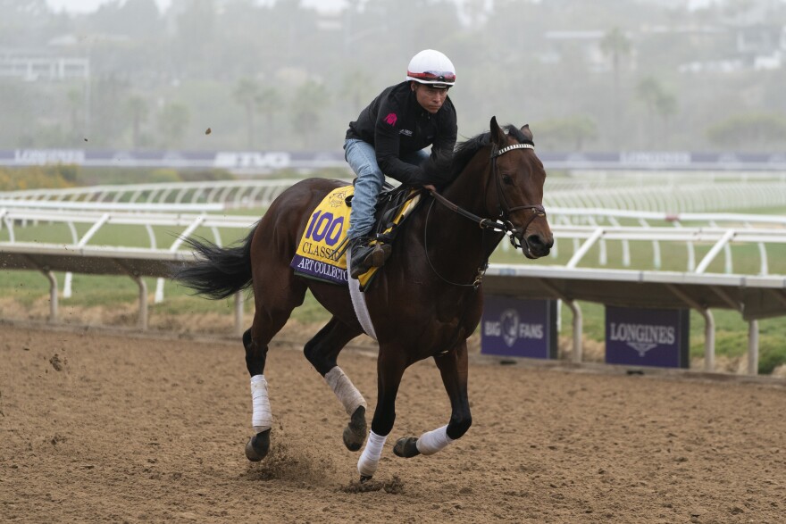 An exercise rider takes Art Collector for a morning workout at Del Mar racetrack prior to the Breeders' Cup World Championship horse races Thursday, Nov. 4, 2021, in Del Mar, Calif.