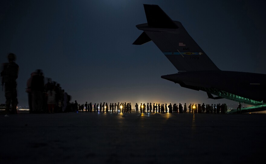 A U.S. Air Force air crew prepares to load evacuees aboard a C-17 aircraft at Hamid Karzai International Airport in  Kabul on Aug. 31. Several public school students from Sacramento, Calif., remain in Afghanistan after the U.S. evacuation ended.