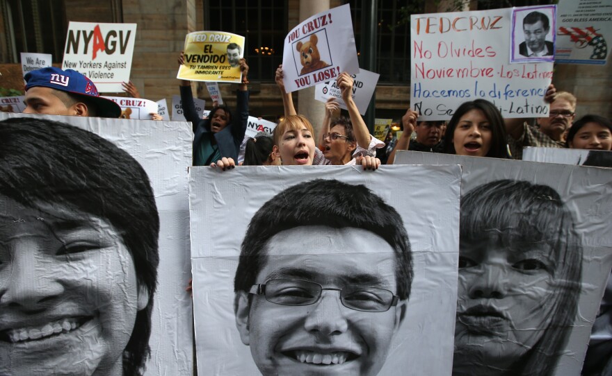 Immigration reform advocates hold signs of young immigrant "dreamers" during a protest outside a fund raising event for Texas Senator Ted Cruz at the Grand Hyatt Hotel on May 29, in Manhattan, New York City.