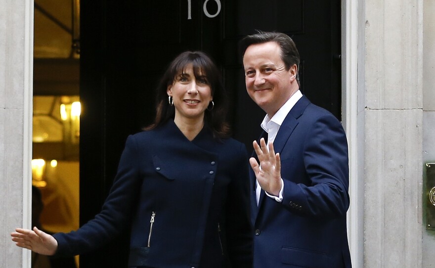 Britain's Prime Minister David Cameron and his wife Samantha return to 10 Downing Street in London on Friday.