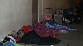 Homeless people bunker down for the night as early as 7 p.m. across the street from the winter homeless shelter. 