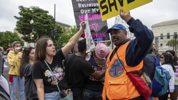An abortion-rights protester, left, faces off against an anti-abortion protester in front of the U.S. Supreme Court in 2022.