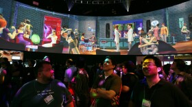 Visitors watch a demonstration of The Sims 2 at E3 on May 19, 2005. The Sims 2 is no longer commercially available on most platforms.