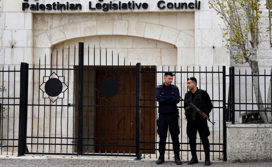 Palestinian security forces gather in front of the Palestinian Legislative Council building in Ramallah in the Israeli-occupied West Bank in December.