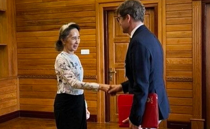 In this photo released by Myanmar President Office on Monday, Aug. 3, 2026, Myanmar's ousted leader Aung San Suu Kyi, left, shakes hands with Arnaud de Baecque, resident representative of the International Committee of the Red Cross, during their meeting in Naypyitaw, Myanmar.