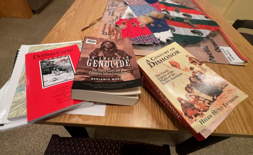 Books on Native American history are shown in the foreground, and the multi-layer map is shown in the background on a table at the Barona Cultural Center & Museum on September 26, 2025.