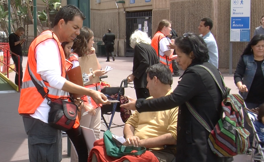 Immigration activists give people crossing the border informative pamphlets about their rights, May 13, 2015.