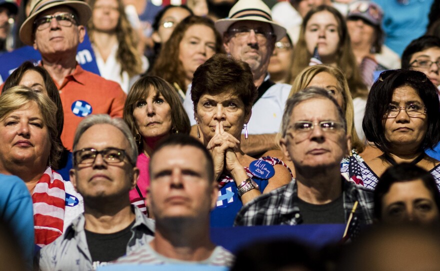Audience members watch as Democratic presidential nominee Hillary Clinton and her vice-presidential running mate Sen. Tim Kaine speak at a rally in Miami, Fla.