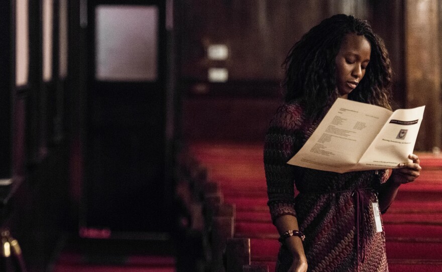 A woman reads a program during a memorial service remembering the victims of the mass shooting at Emanuel African Methodist Episcopal (AME) Church.