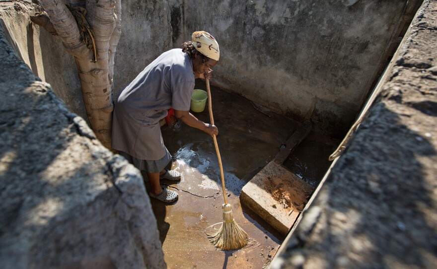 In Mozambique, a woman washes a bathroom at the Maguiguana Primary School. But many of the children don't like using the toilet there. "It's really bad," says a 12-year-old girl. Improvements are expected, thanks to a project by Water and Sanitation for the Urban Poor, a London-based nonprofit.