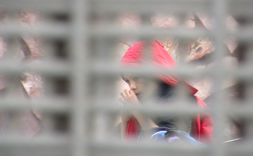 A young boy can be seen in Tijuana through the U.S.-Mexico border fence, Dec. 19, 2015. 