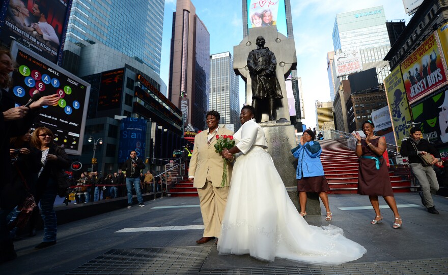 Chris (right) and Renee Wiley pose for a wedding photo on Times Square in New York in December. Same-sex marriage in New York state became legal in July 2011.