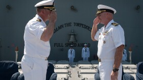 Capt. Timothy Kott, right, relieves Capt. Thomas Halvorson, left, as commanding officer of the Ticonderoga-class guided-missile cruiser USS Mobile Bay (CG 53) during an at sea change of command ceremony. 