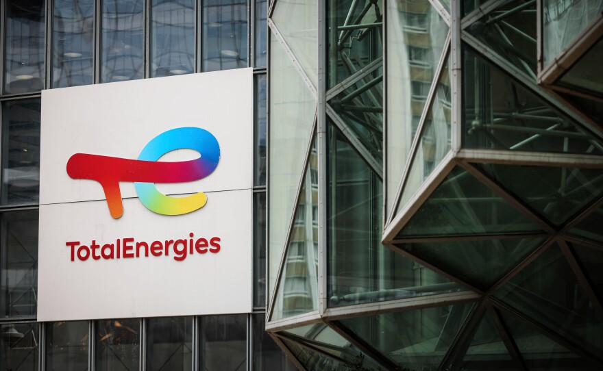 A sign for the French company TotalEnergies is displayed at headquarters March 21, 2025, in La Defense business district outside of Paris.