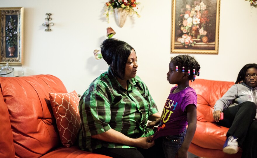 Bertha Martin greets her great-granddaughter, Essiayah Martin, 5, as she comes in the door of their newly renovated home.