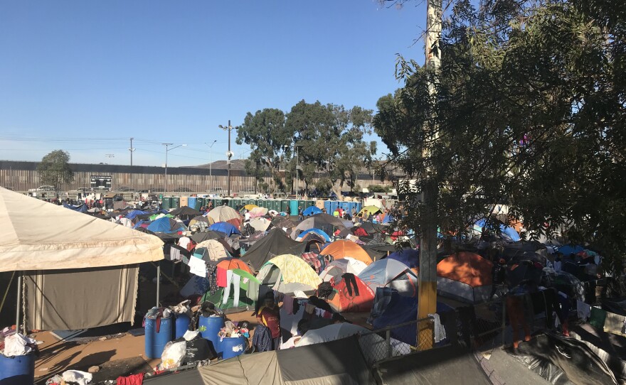 Tents are lined up in sports complex turned shelter in Tijuana by the border fence, Nov. 26, 2018.