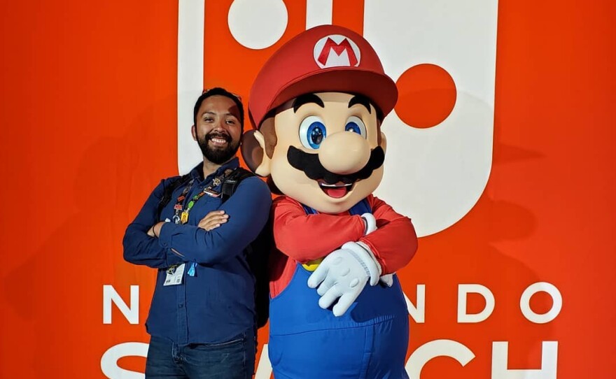 Ivan Tajonar, also known as Vantaj on Twitch, poses next to Mario, a character from popular Nintendo games in this undated photo.
