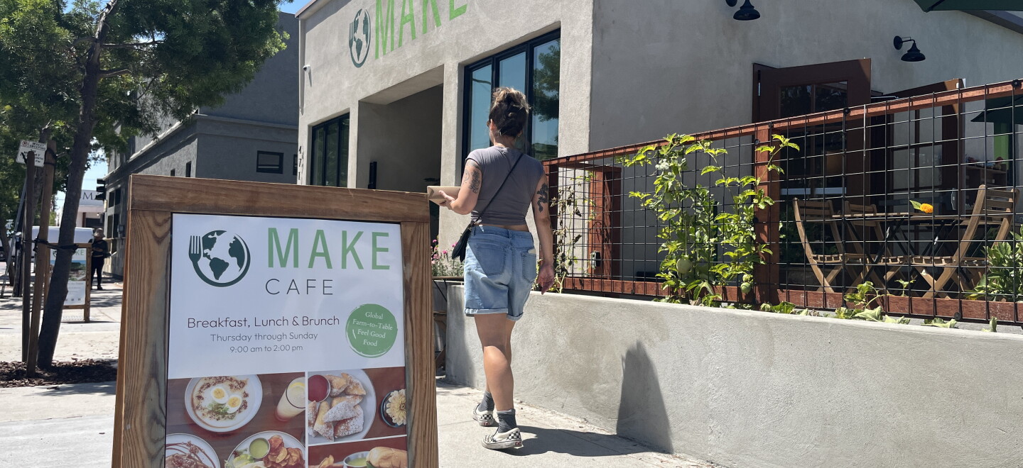 A woman walks by the Make Cafe building in Normal Heights, Aug. 21, 2026.