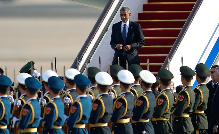 President Barack Obama arrives at the Beijing airport Monday. Speaking at the APEC 2014 Summit, the president unveiled a new deal to ease visa restrictions between the U.S. and China.