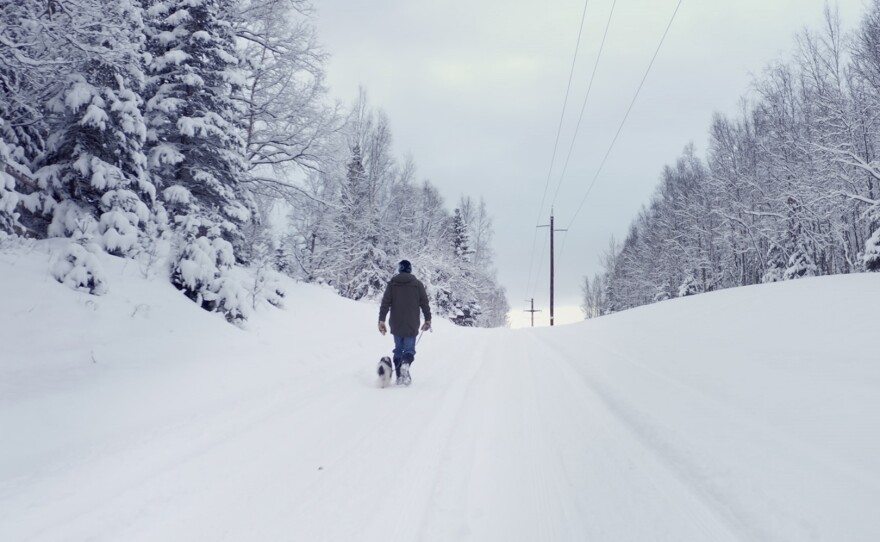 Peter Dunlap-Shohl with his dog outside his home in Anchorage, Alaska