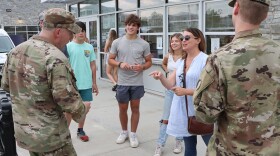 Recruiters and other Virginia National Guard soldiers talk with fans at a July 2022 minor league baseball game in Fredericksburg. Any Virginia resident can collect a finder’s fee up to $750 for referring somebody who becomes a National Guard recruit.