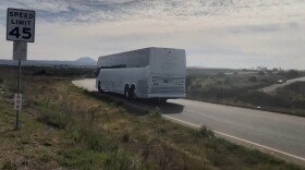A bus carrying evacuees who have been cleared of coronavirus and released from quarantine at Marine Corps Air Station Miramar leaving the base pm Feb. 20. 2020.