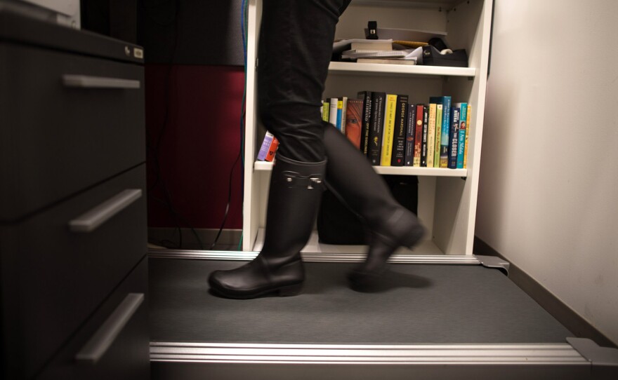 NPR senior Washington editor Beth Donovan walks on a treadmill desk in her office in Washington, D.C.