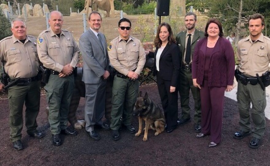 San Diego City Attorney Mara Elliott (middle) and California State Senator Toni Atkins (second, right) stand with officers from California's Department of Fish and Wildlife. The group announced charges in an ivory trafficking case Tuesday.