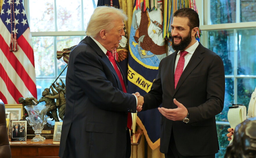 FILE - In this photo released by Syrian Presidency press office, President Donald Trump, left, shakes hands with Syria's President Ahmad al-Sharaa, at the White House in Washington, Monday, Nov. 10, 2025.