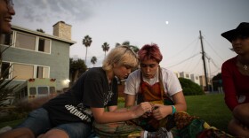 San Dieguito senior Mace Viemeister sits with his girlfriend Chloe Milliken and friends Joy Ruppert, left, and Issie Slentz, right, at a beach overlook in Encinitas, Oct. 4, 2022. Viemeister is one of the students who has spoken out against a district trustee and a controversial Facebook group chat.