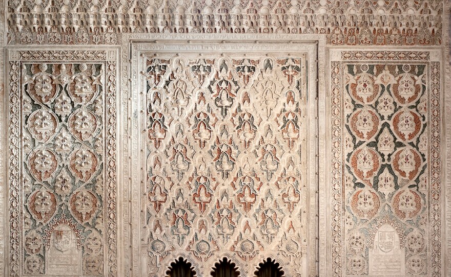 The interior of the 14th-century El Transito synagogue in Toledo, Spain. The synagogue's walls are intricately carved with Hebrew prayers, in marble and gold, and Moorish designs — representing the mix of Jewish and Arab traditions that coexisted in Spain during the Middle Ages. Here you can see the knave of the synagogue, where Torah scrolls were once kept.