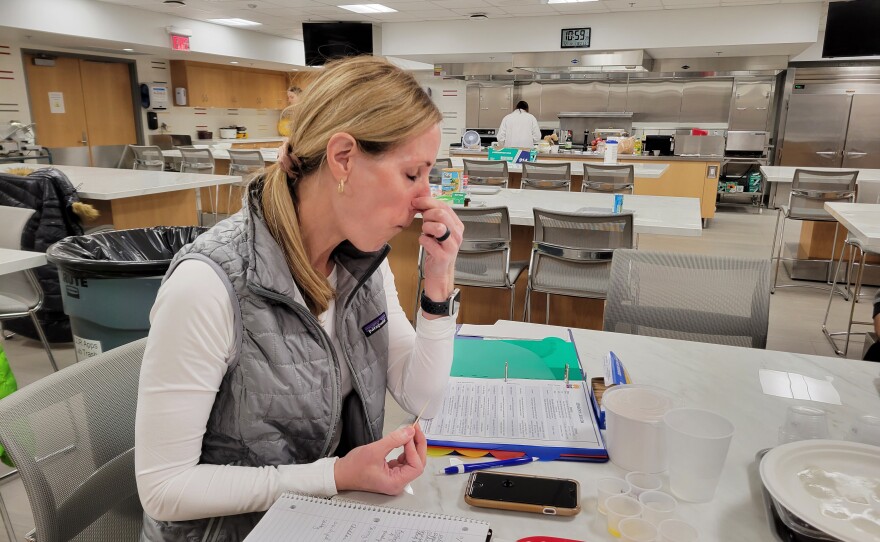 New taster Kelly Kluck plugs her nose as she tastes cheese. She has already earned a few wine tasting certifications.