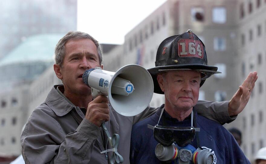President George W. Bush, left, surveying the damage at the site of the World Trade Center on Sept. 14 2001 in New York City, just three days after the terrorist attack that brought down the towers.