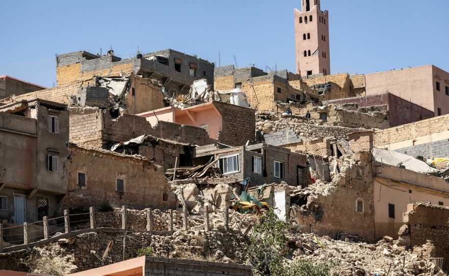 The minaret of a mosque stands behind damaged or destroyed houses following an earthquake in Moulay Brahim, Al-Haouz province, on Saturday.